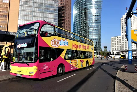 East and West Berlin hop-on hop-off bus tour passing Karl-Marx-Allee