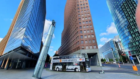 Berlin hop-on hop-off tour bus with live commentary guide passing Potsdamer Platz